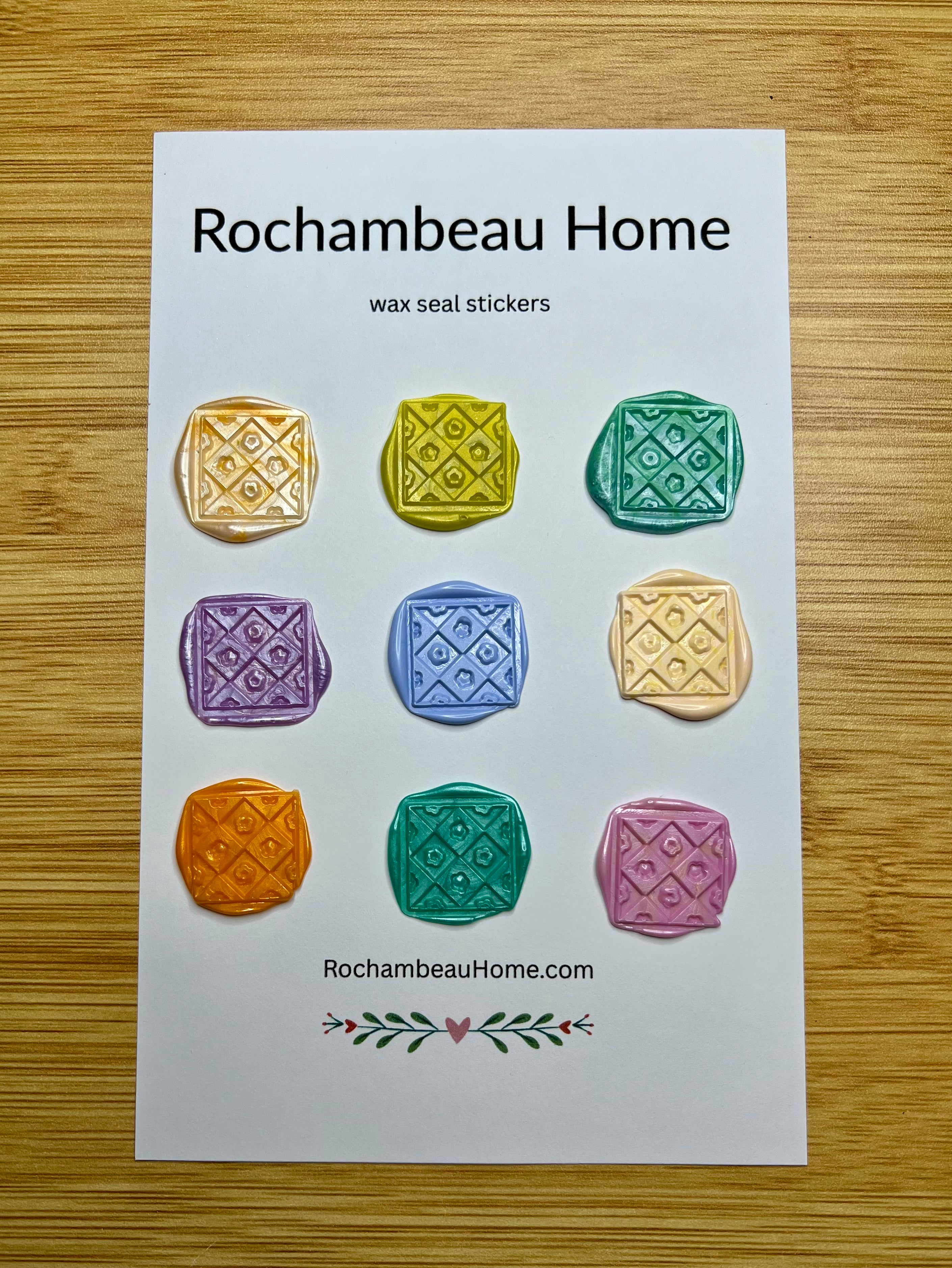 Close up view of the Cozy Quilted Flower wax seal stickers in a variety of colors on a 9 pack card
