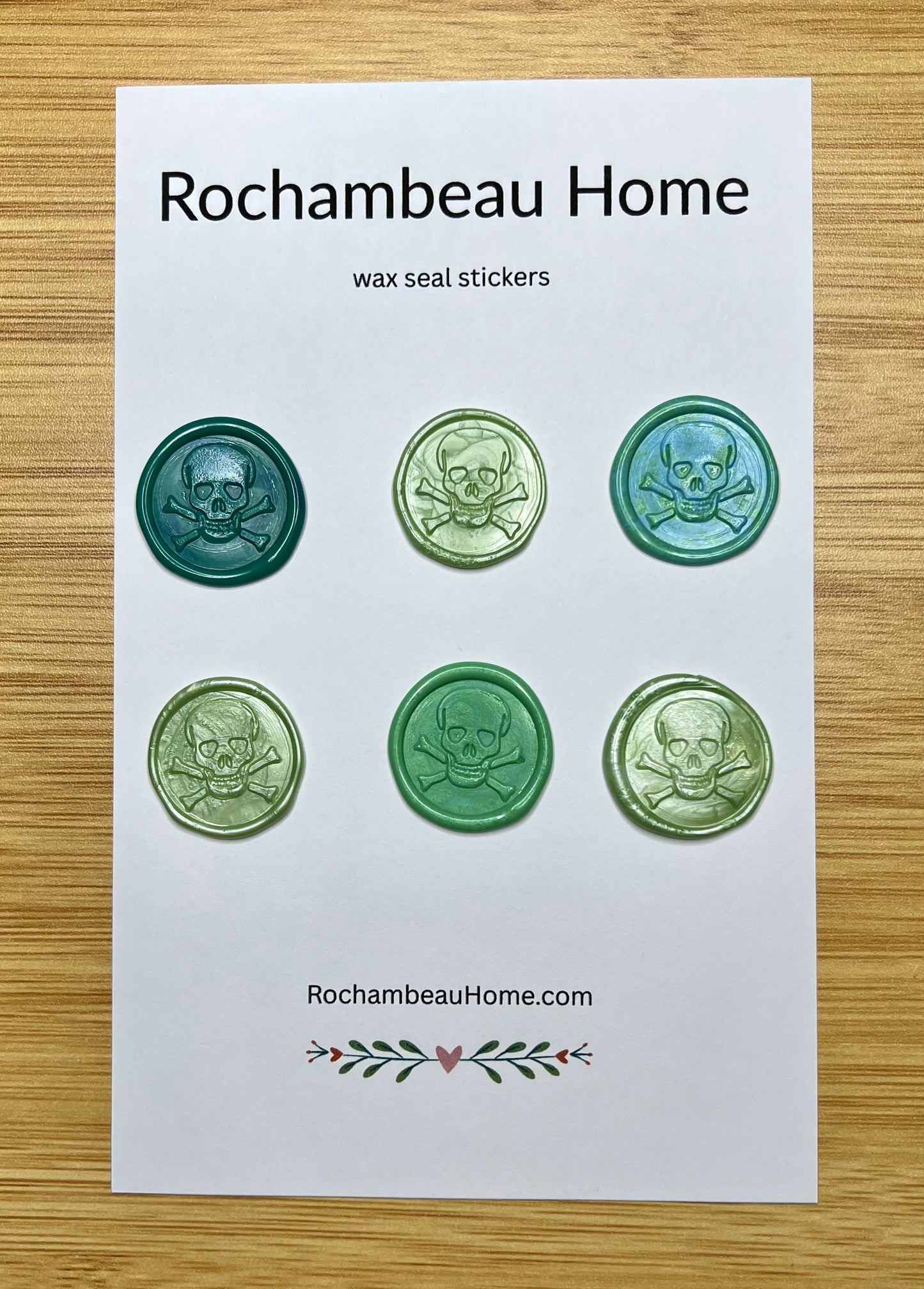 Close up view of the Skull & Crossbones wax seal stickers in a green theme