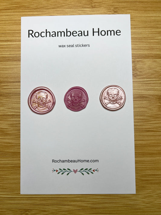 Close up view of the Skull & Crossbones wax seal stickers in a pink theme