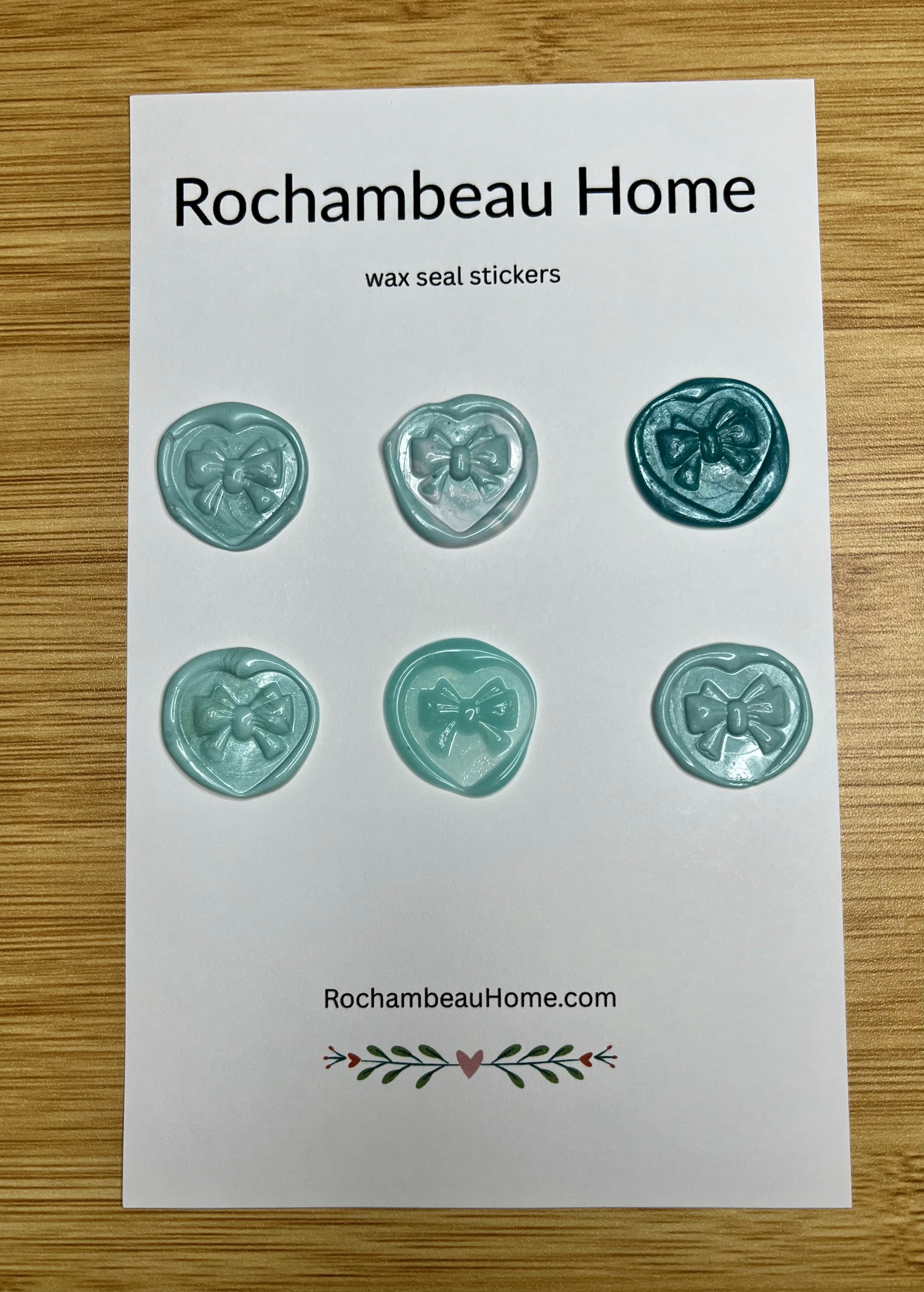 Close up view of the Heart & Bow wax seal stickers in a blue hue