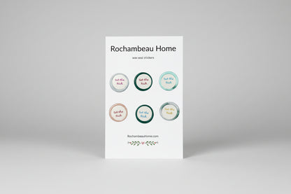 Close up view of the Eat the Rich wax seal stickers created by Rochambeau Home on a 6 pack card