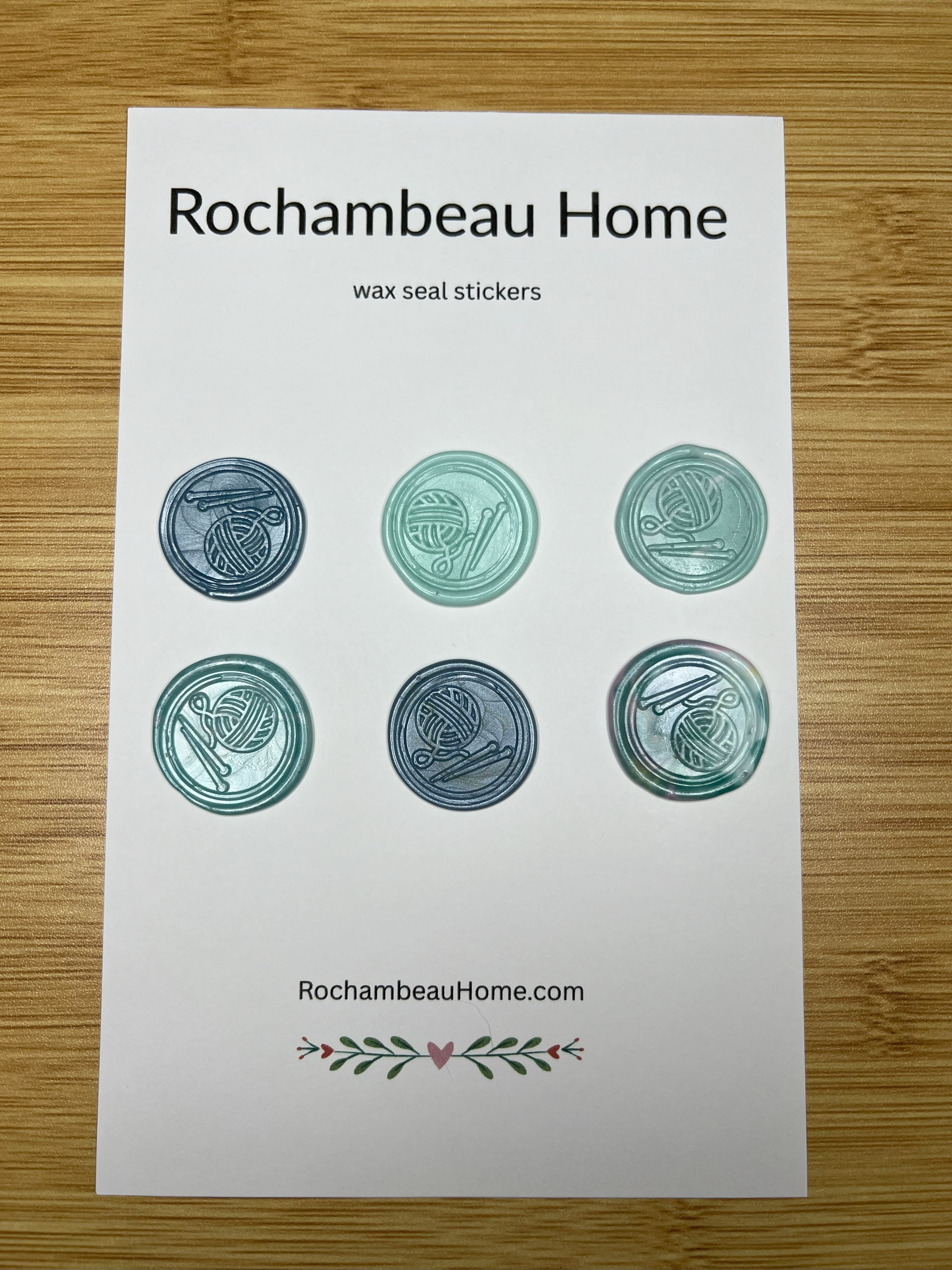 Close up view of the Handcrafted Knitting Circle wax seal stickers in a blue hue