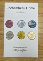 Close up view of the Spirals of Nature Ammonite wax seal stickers in a variety of colors on a 6 pack card