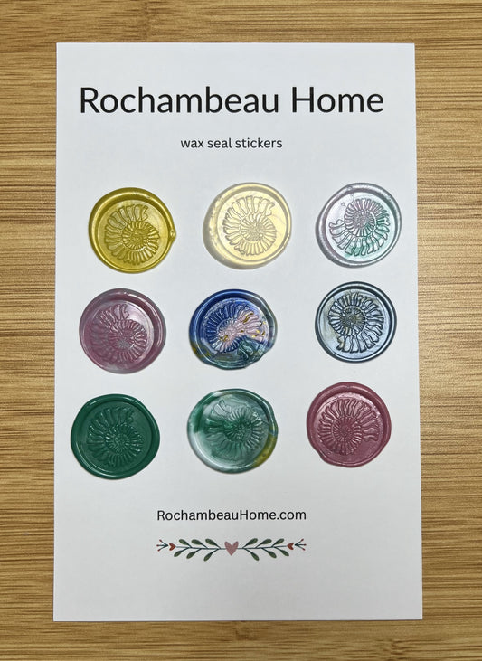 Close up view of the Spirals of Nature Ammonite wax seal stickers in a variety of colors on a 9 pack card