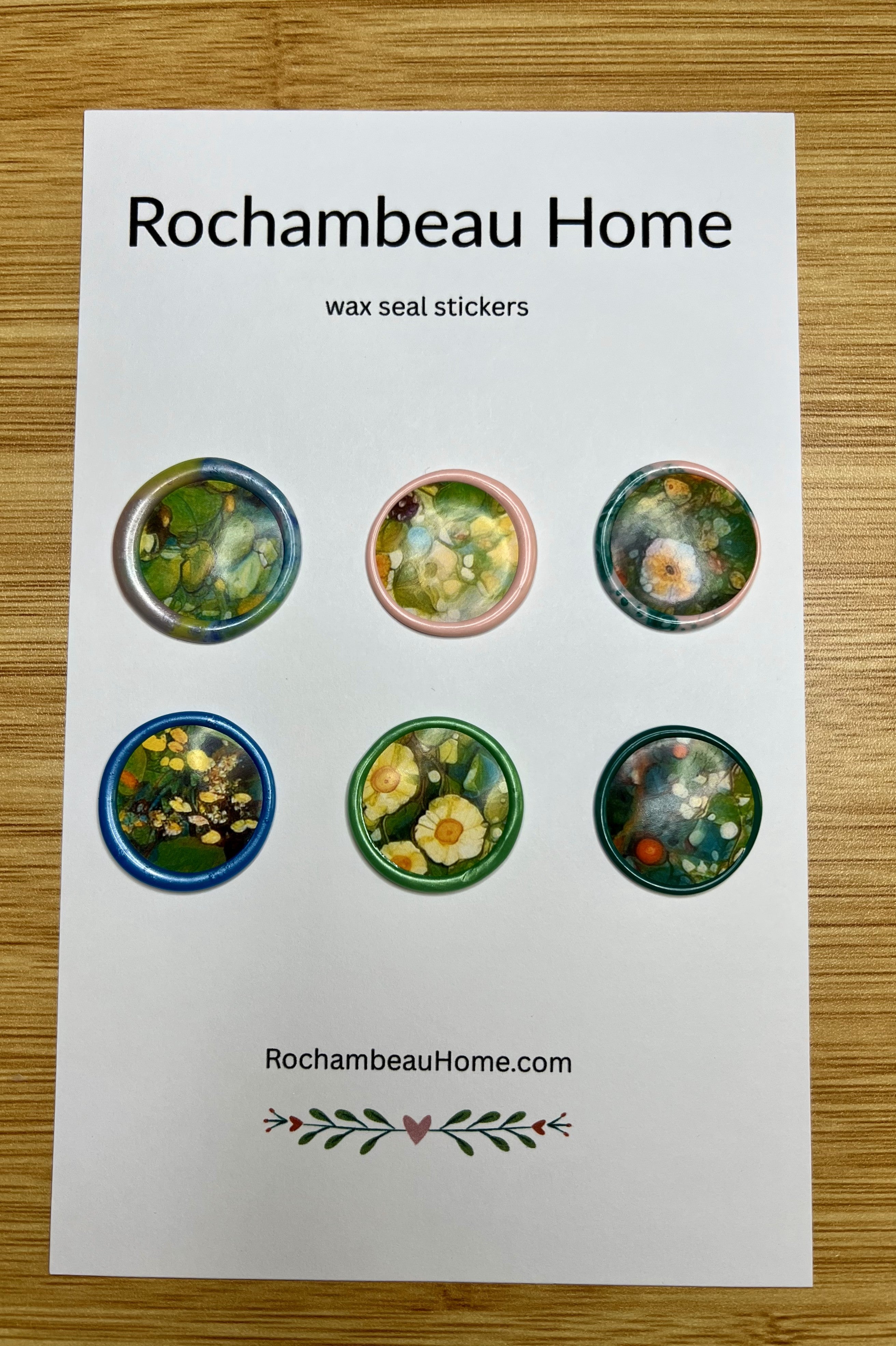 Close up view of 6 Watercolor wax seal stickers on a paper card display