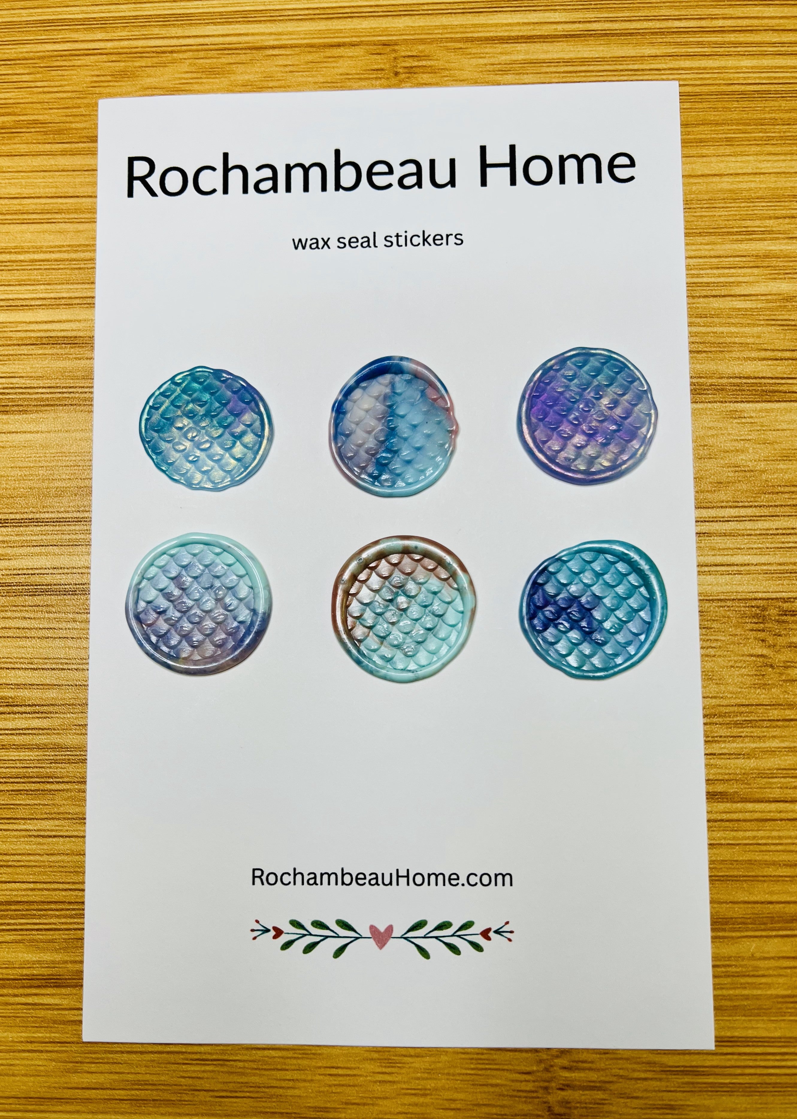 Close up view of the Tide & Trinket Mermaid wax seal sticker on a 6 pack card