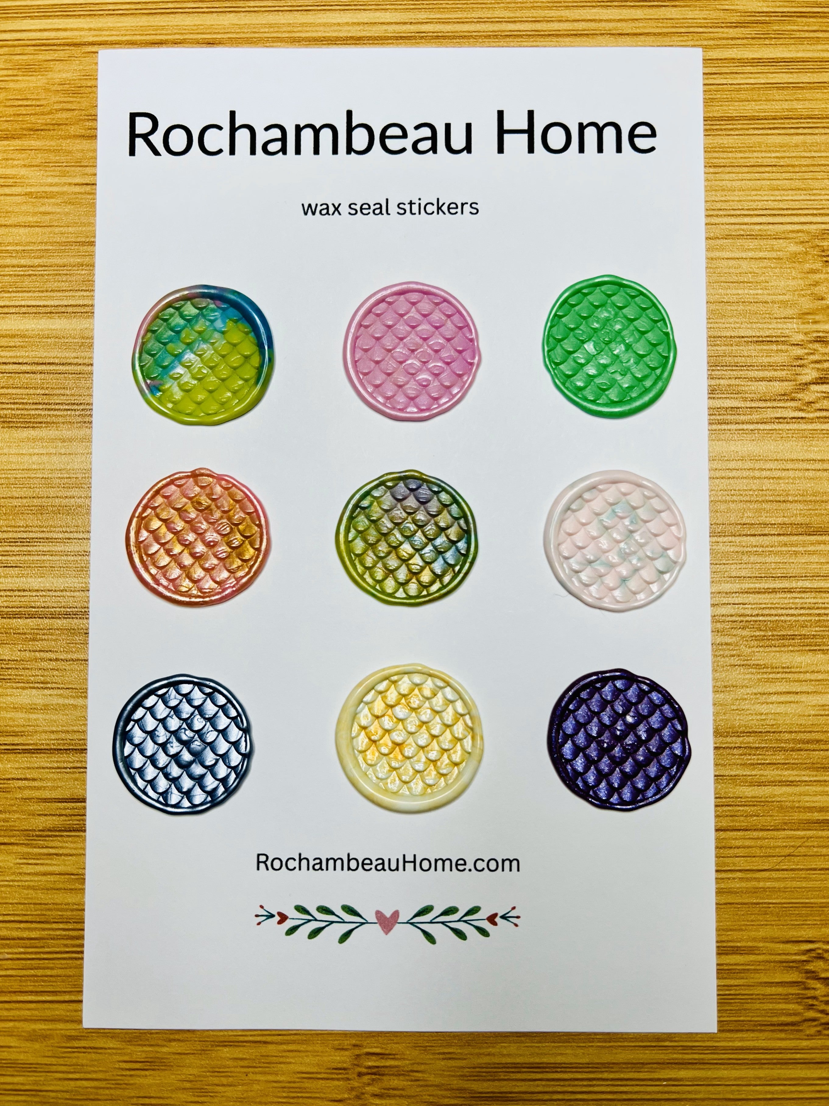 Close up view of the Hiss & Tell wax seal stickers on a 9 pack card