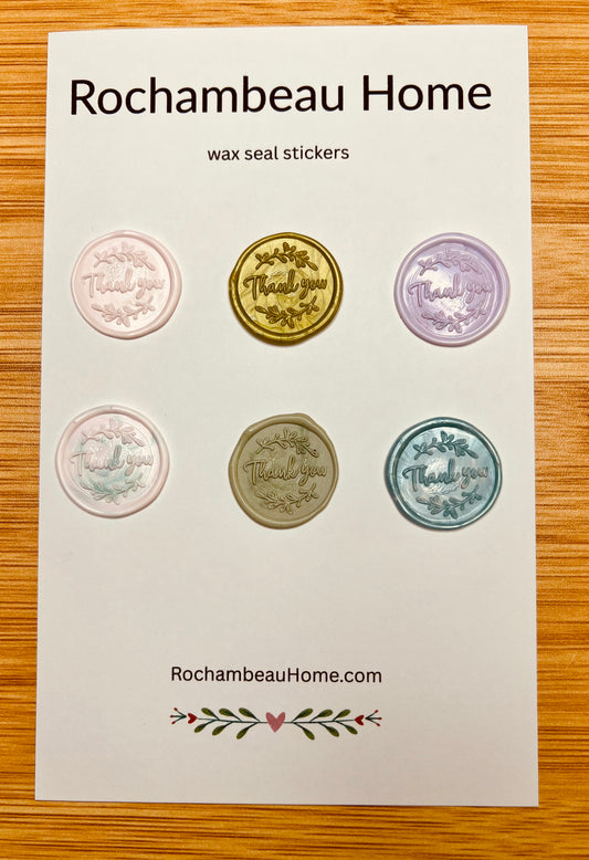 Close up view of the "Thank You" (Style 1) wax seal stickers in a variety of colors on a 6 pack card