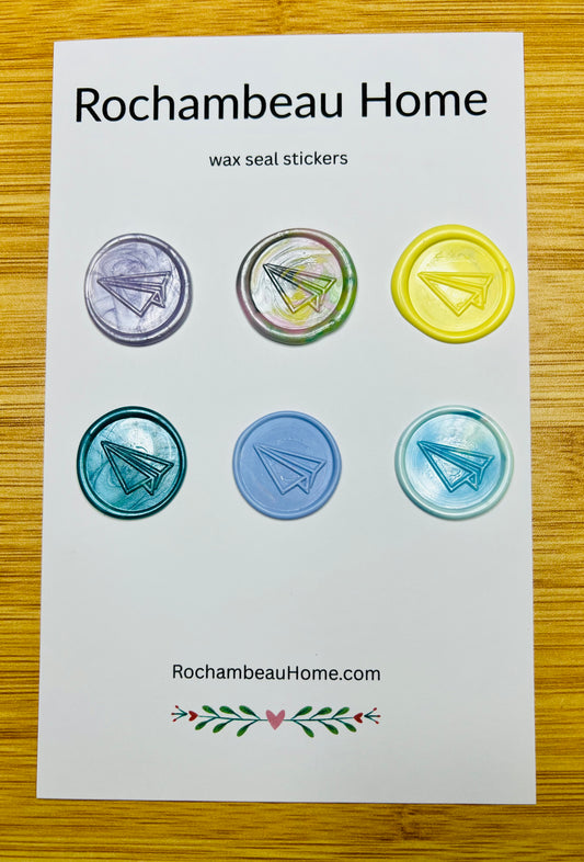 Multicolor wax seals featuring embossed paper airplane on a display card