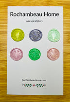 Close-up of Olive You Always embossed olive branch wreath wax seal stickers on a 6 pack card in a Solid Multicolor palette