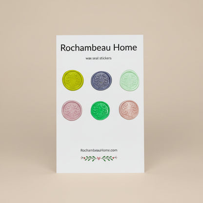 Close-up of Olive You Always embossed olive branch wreath wax seal stickers created by Rochambeau Home on a 6 pack card in a Solid Multicolor palette