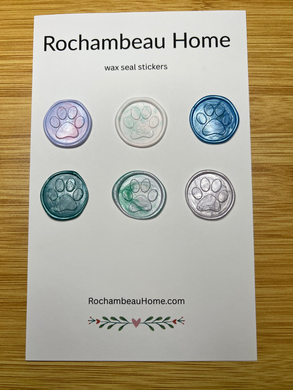 6 multicolor paw print wax seal stickers arranged on a display card