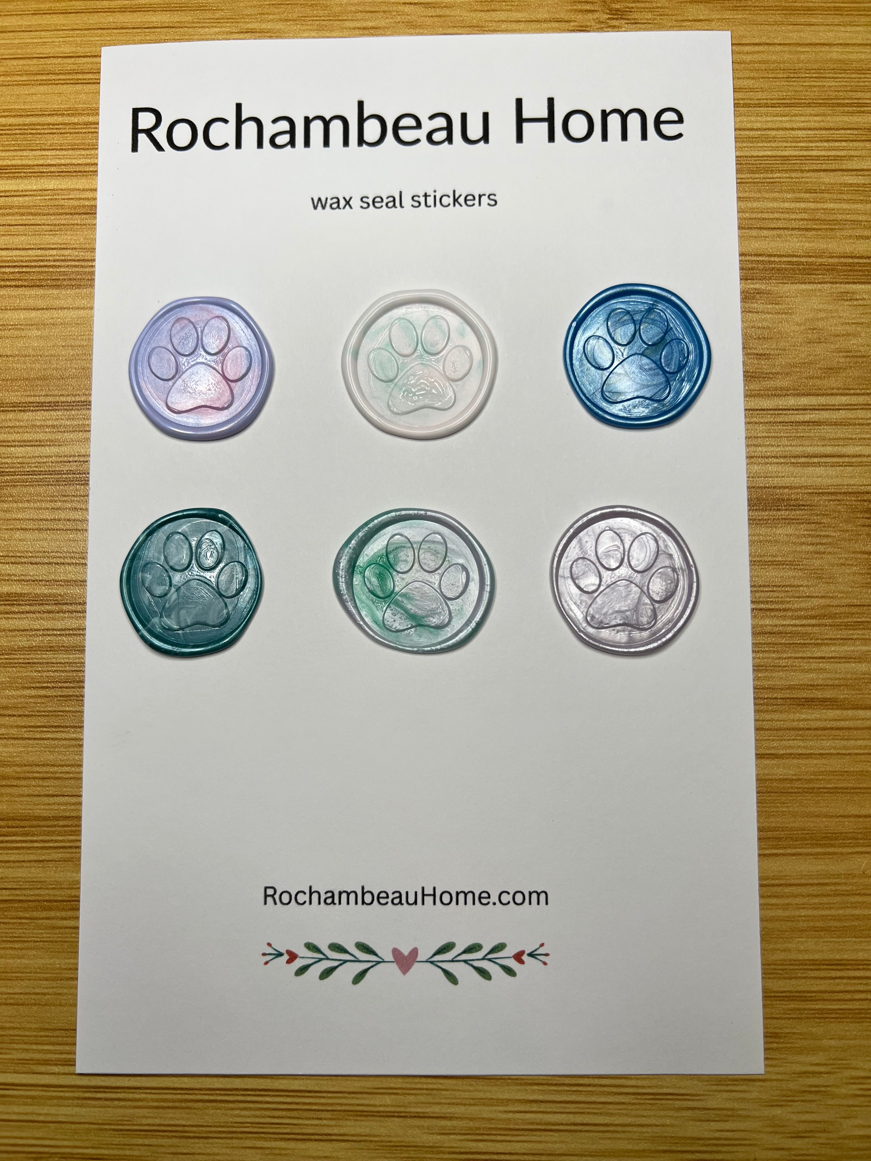 6 multicolor paw print wax seal stickers arranged on a display card