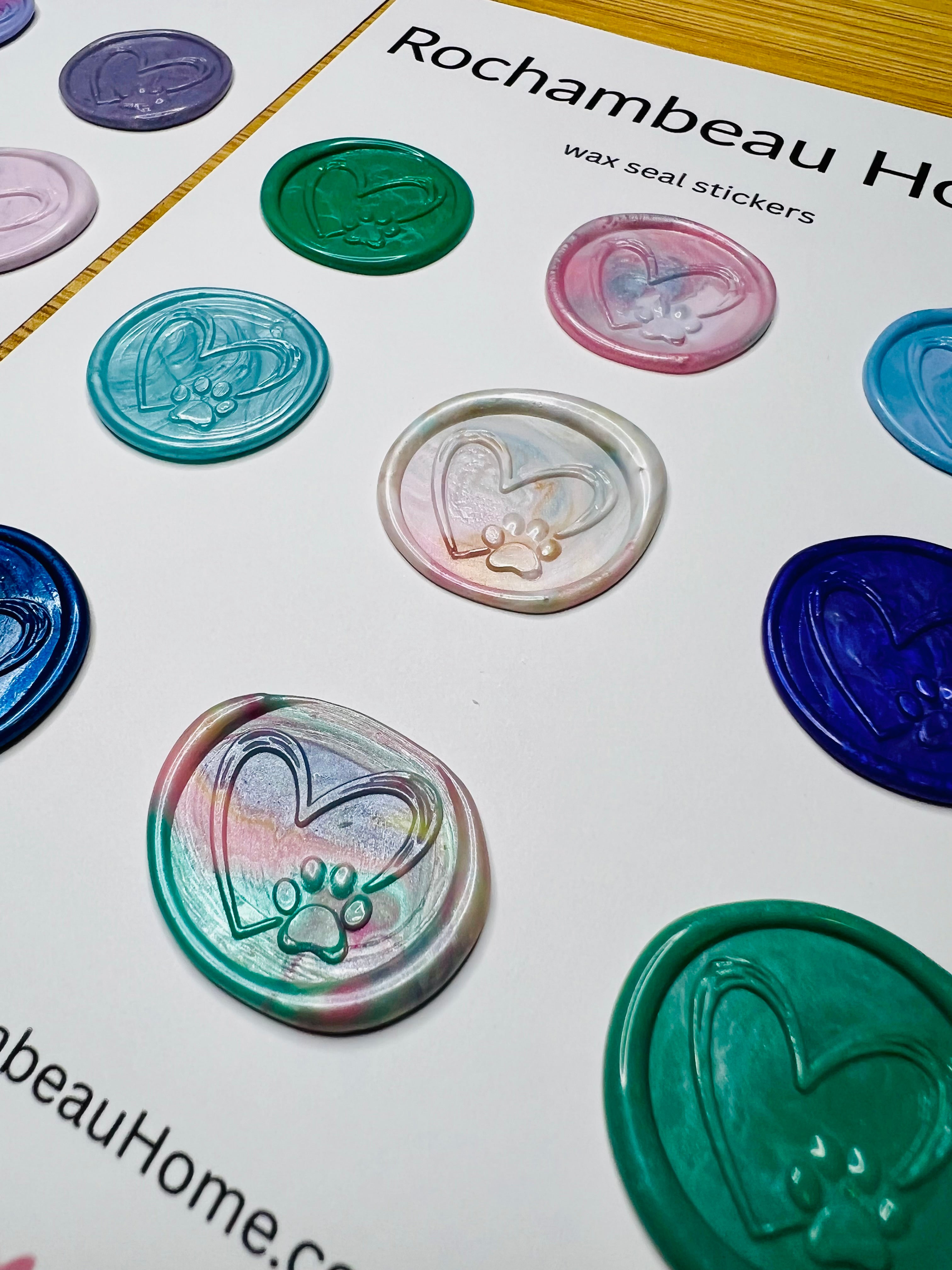 Close-up of embossed paw print inside a hand-sketched heart in artisan wax