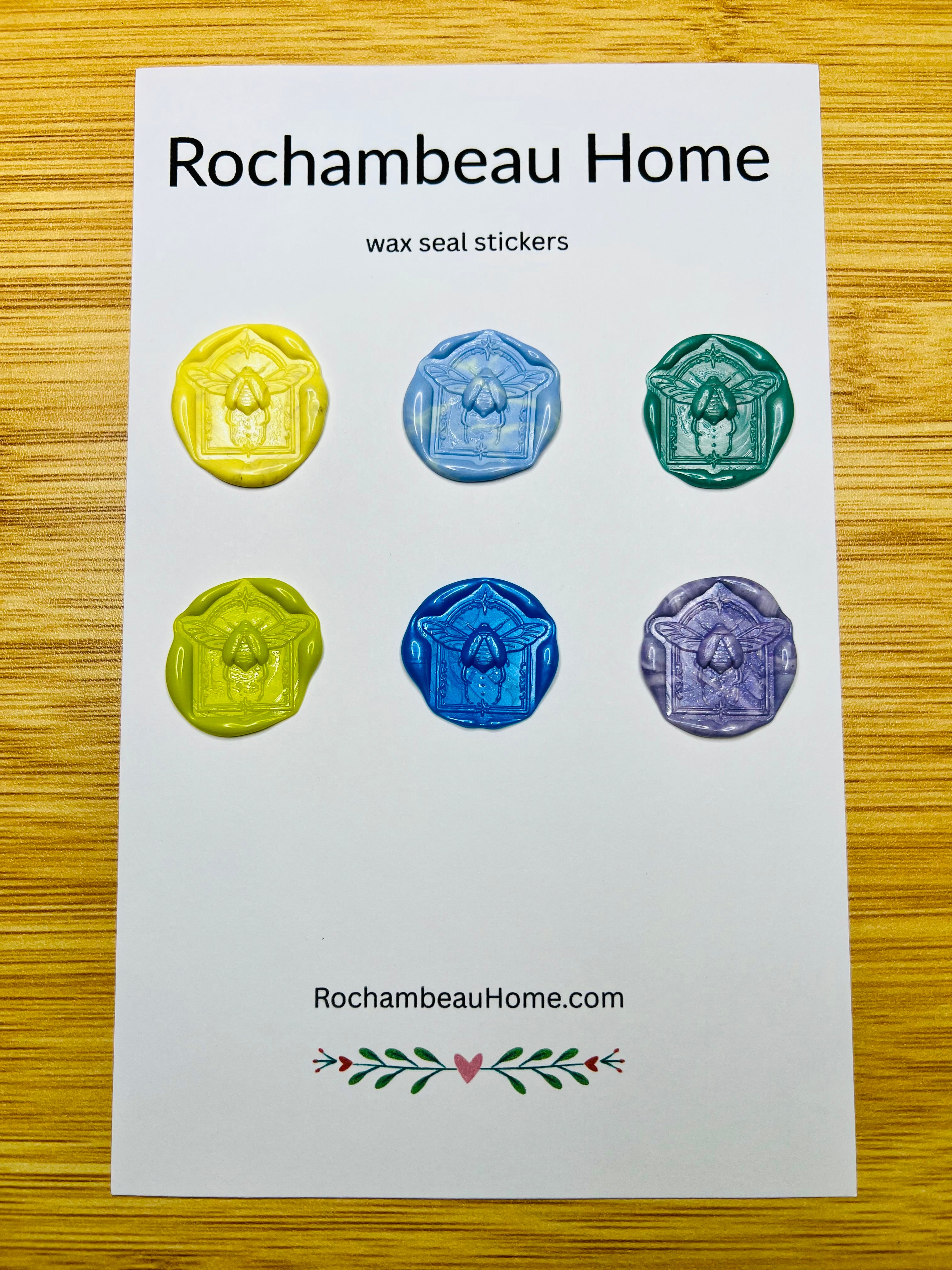 Handmade scarab beetle wax seals in rich colors, displayed on a backing card