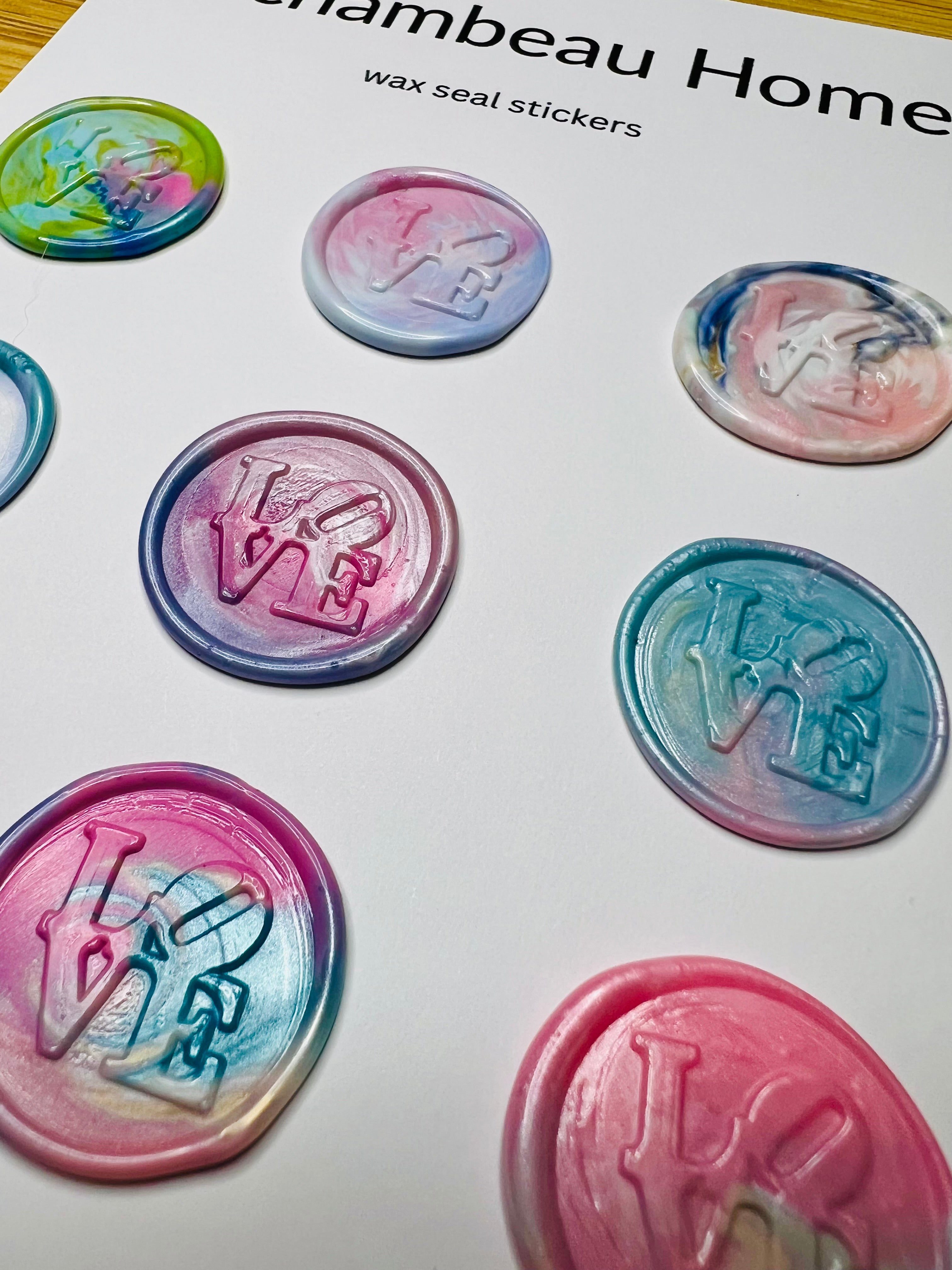 Close-up of LOVE wax seal showing sculptural detail and glossy finish