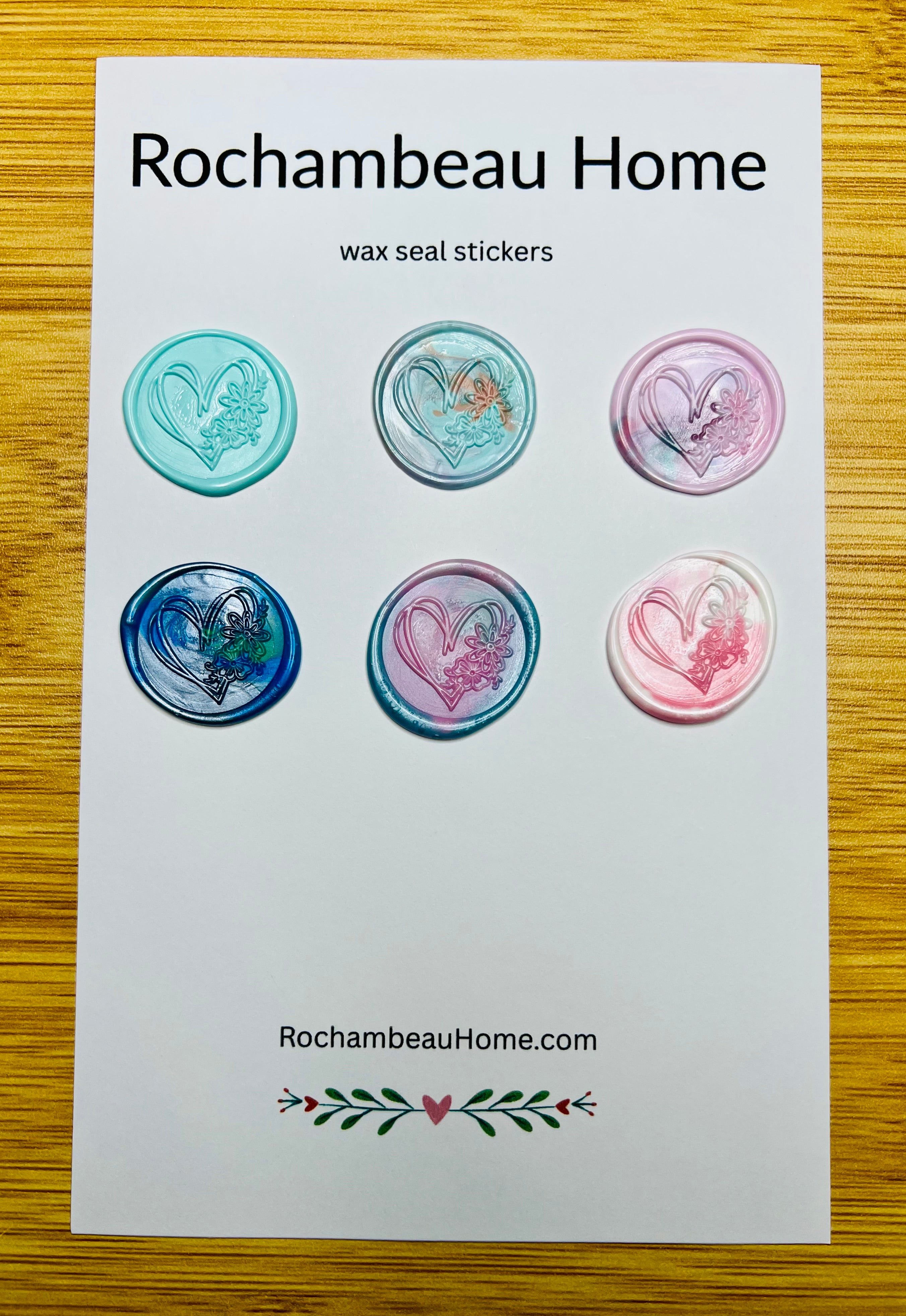 Hand-drawn heart wax seal stickers with floral detailing in multicolor tones on a 6 pack card