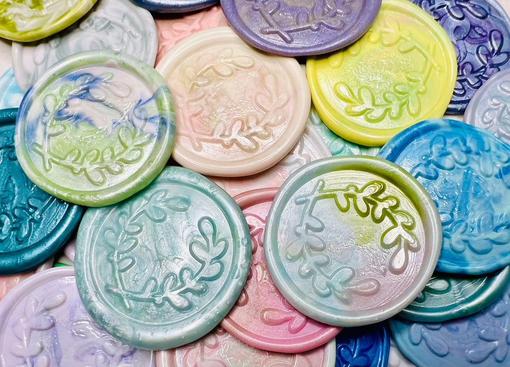 A close up view of the Rainbow Multicolor variation of the Olive You Always wax seal stickers