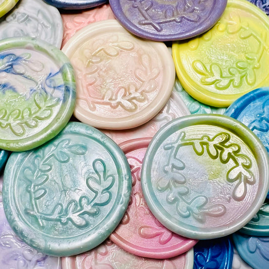 A close up view of the Rainbow Multicolor variation of the Olive You Always wax seal stickers