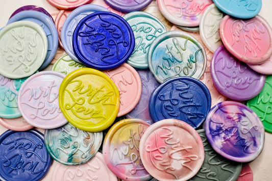 A close up view of the "With Love" wax seal stickers in the Rainbow Multicolor theme