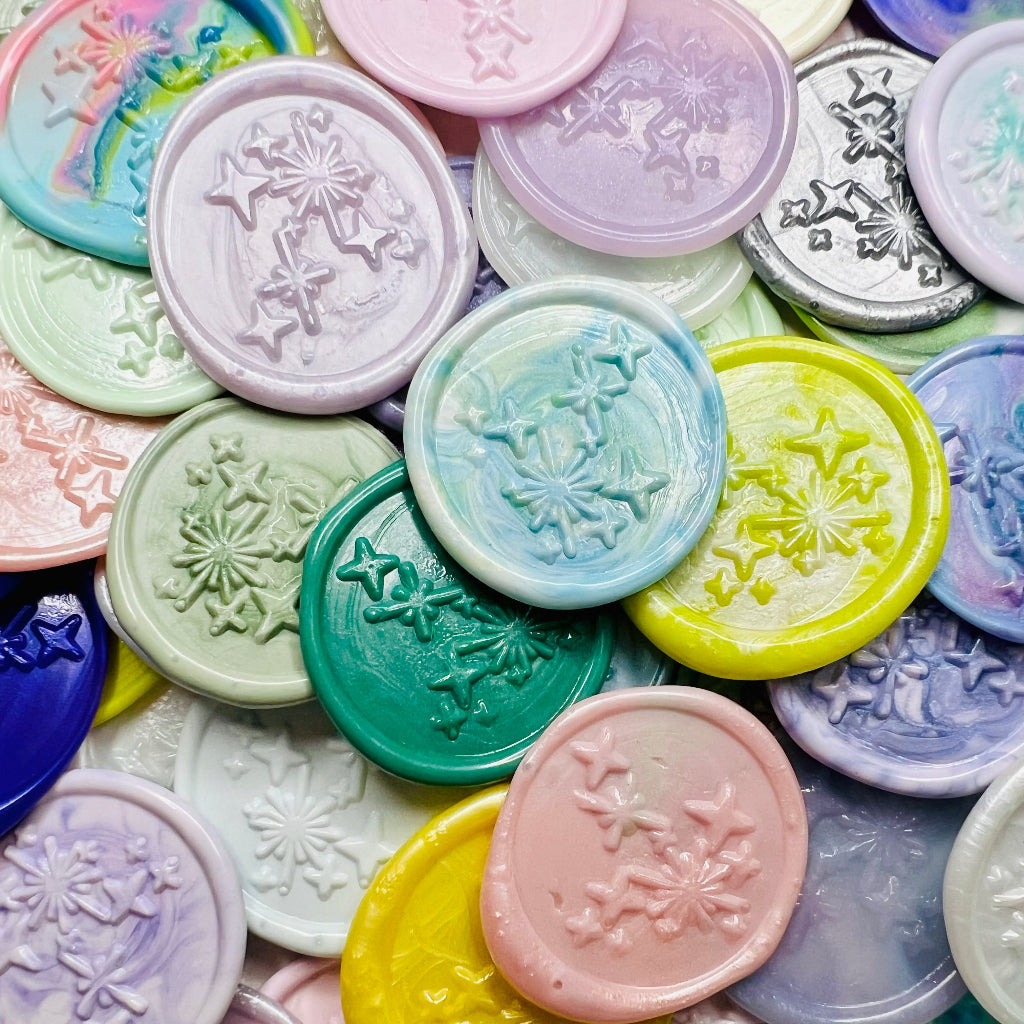 A close up view of the Written in the Stars wax seal stickers from Rochambeau Home Gifts  in various colors