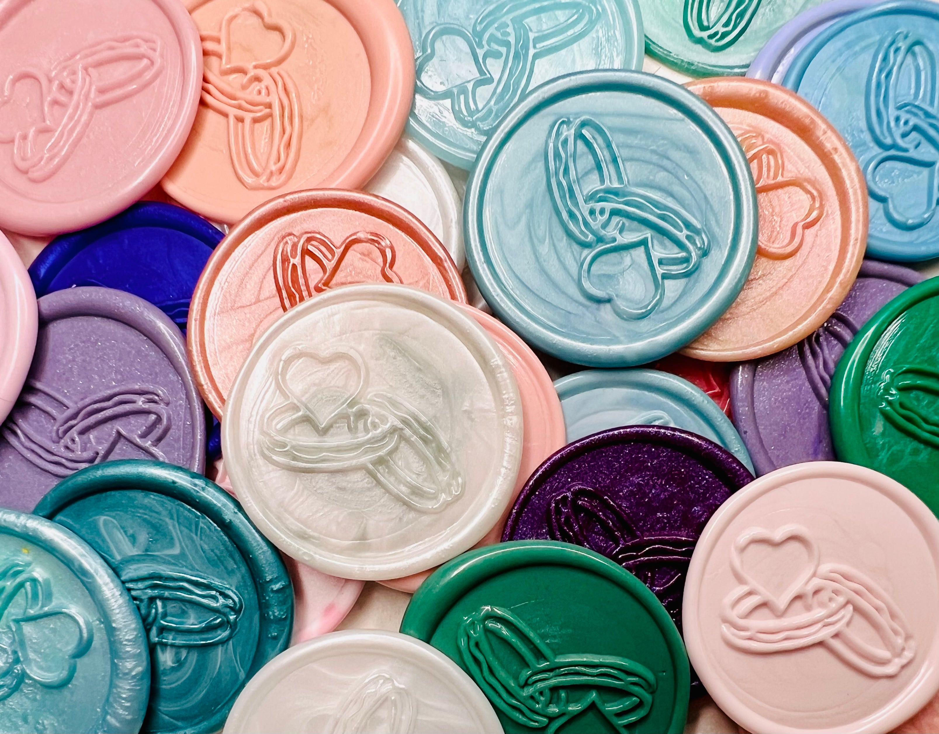 Close up view of Bound in Love wax seal stickers in various colors