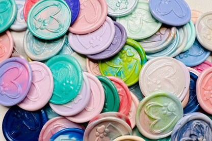 Beautiful and heartfelt wax seal stickers embossed with a handdrawn paw and heart in various colors.