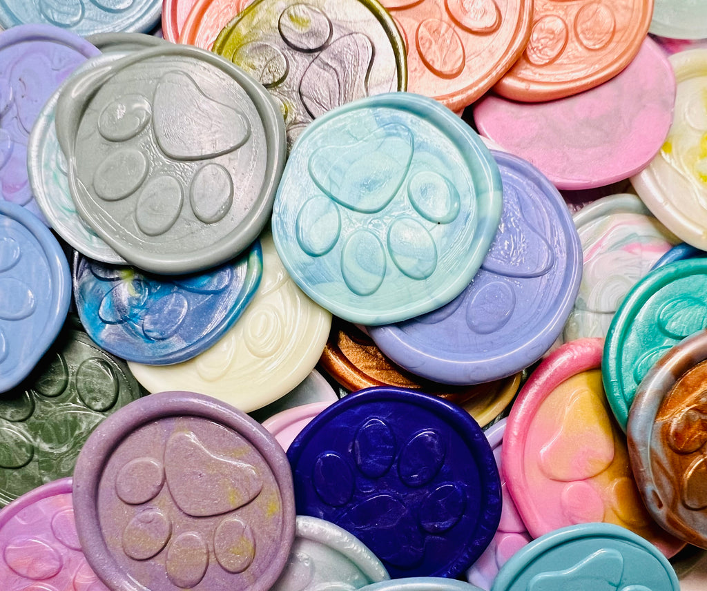 Close up view of various Little Print wax seal stickers 