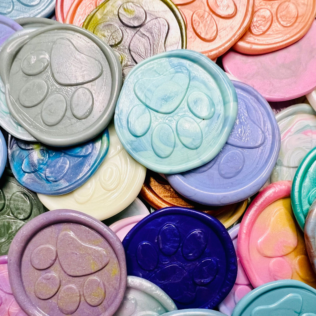 Close up view of various Little Print wax seal stickers from Rochambeau Home Gifts in various colors