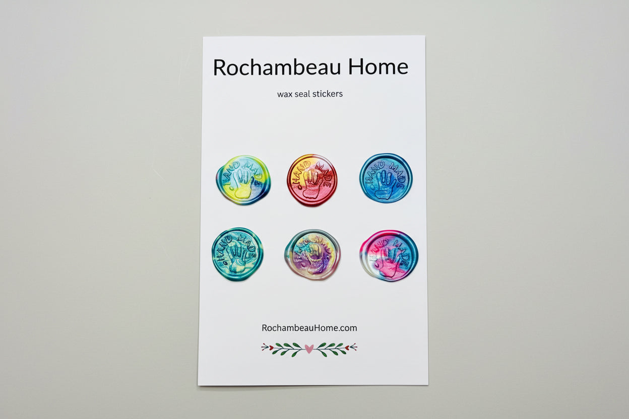 “Hand Made” wax seal stickers created by Rochambeau Home with 3D embossed handprint in a rainbow multicolor theme