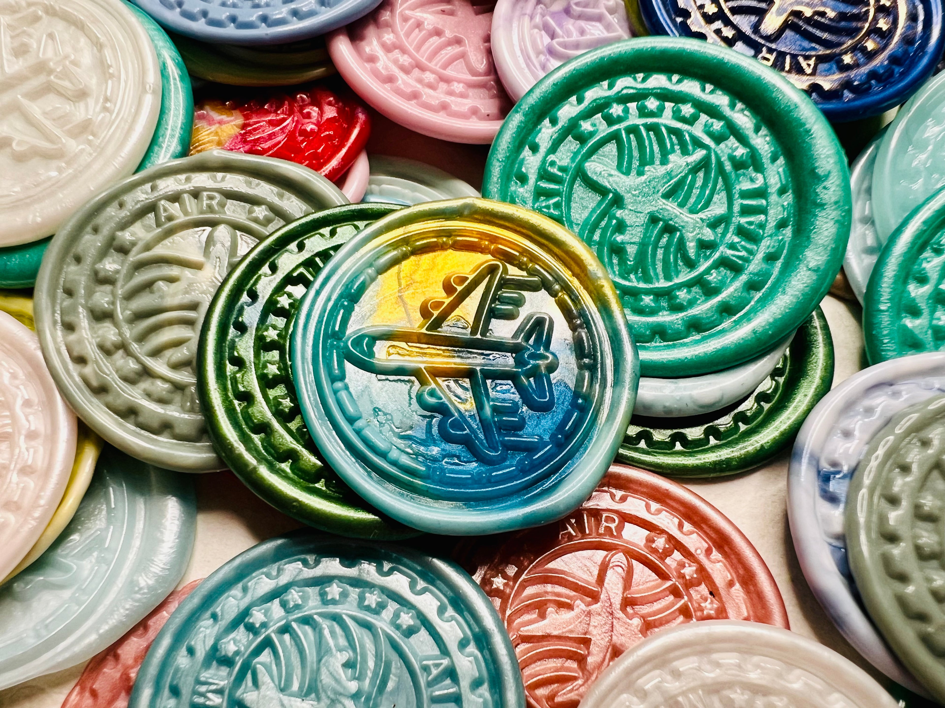 Close up view of the Vintage-Inspired Airplane wax seal sticker in a multicolor theme