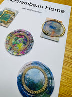 Close-up of a wax seal with silver brushed accents over a painted-style countryside scene (Art Deco 001)