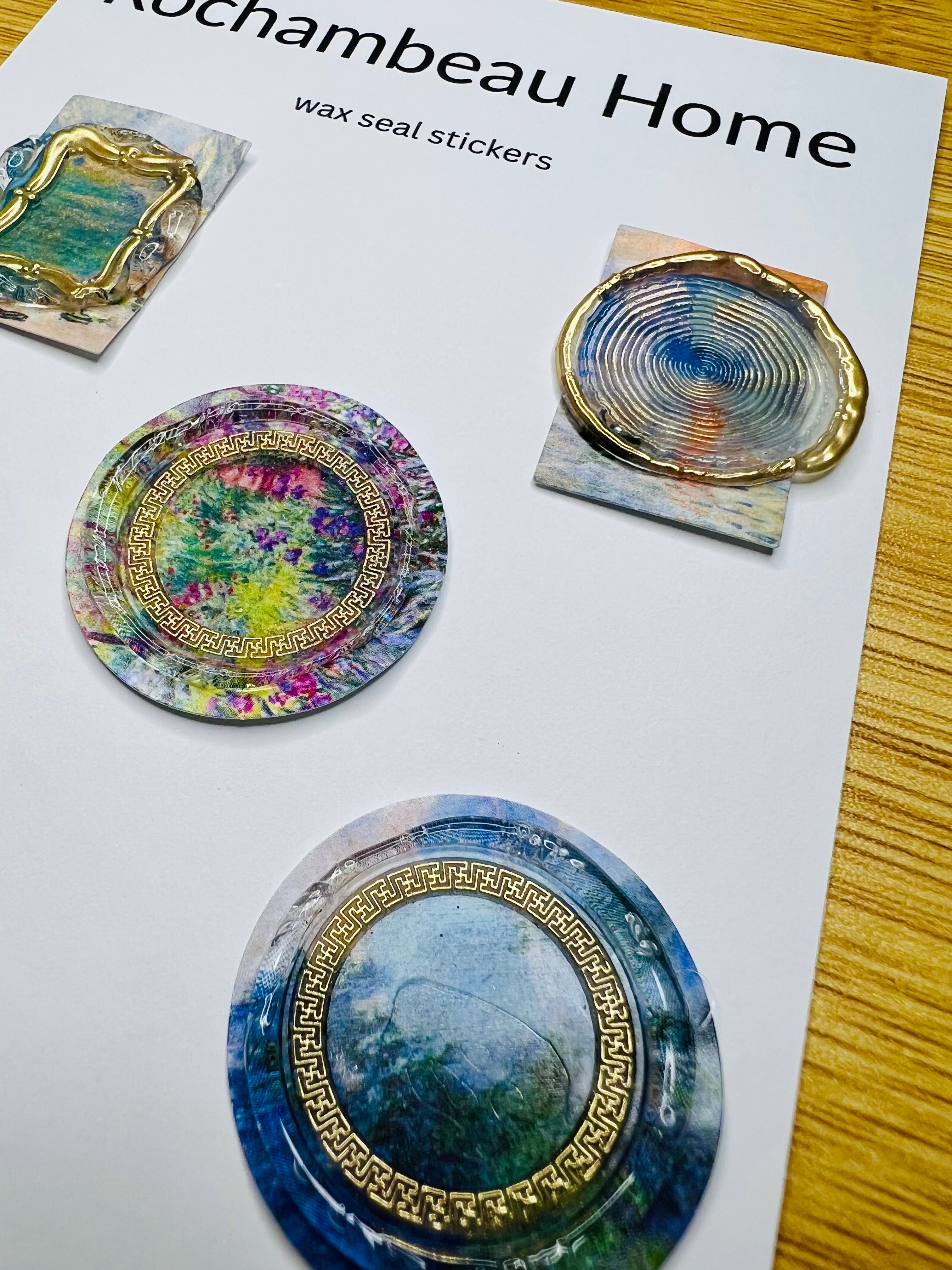 Close-up of a wax seal with silver brushed accents over a painted-style countryside scene (Art Deco 001)