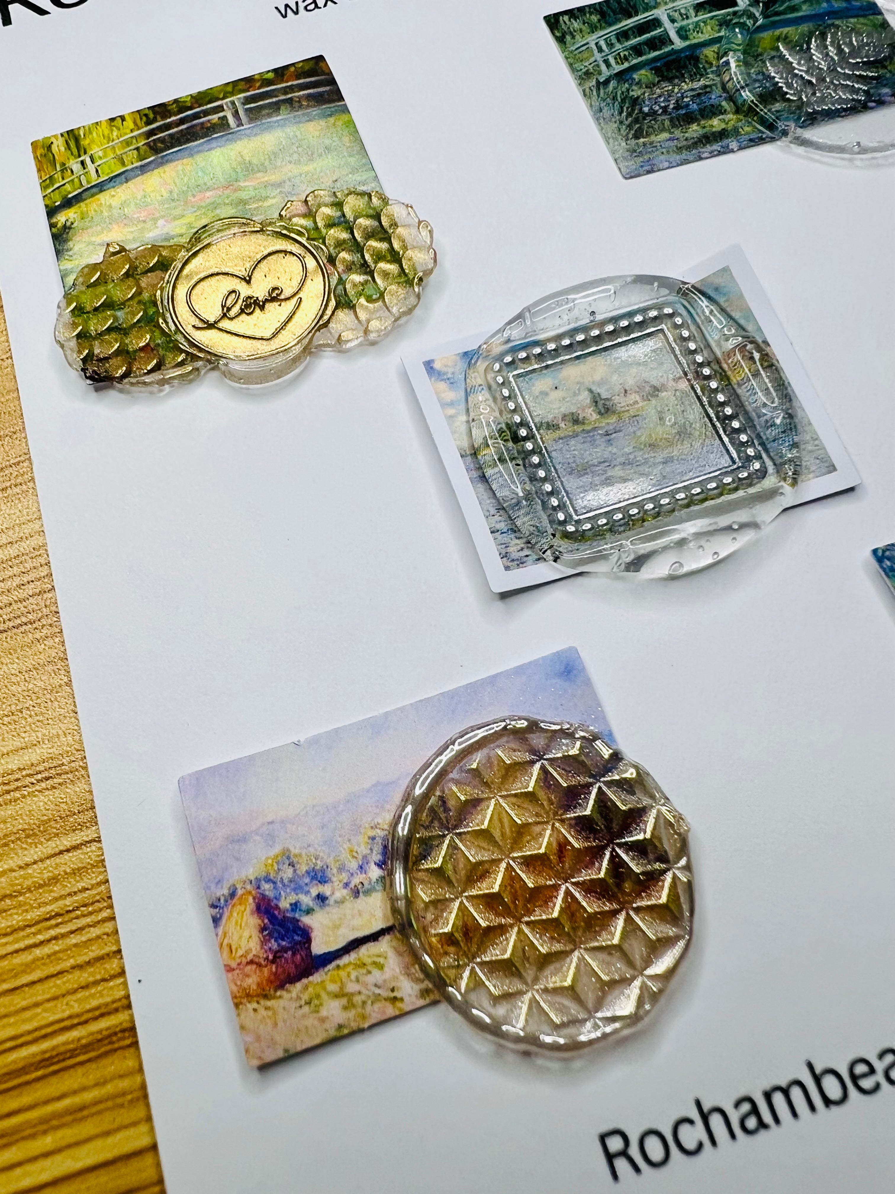 Hand brushing gold accents onto a wax seal sticker featuring art deco-inspired scenery (Art Deco 002)