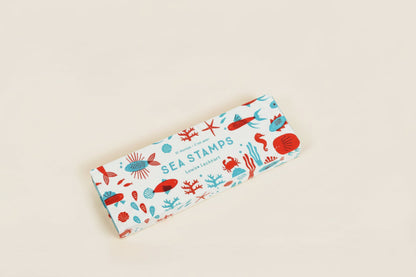 Colorful rubber stamp set featuring ocean-themed shapes like fins, shells, and tails