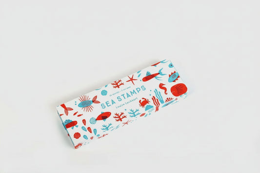 Colorful rubber stamp set featuring ocean-themed shapes like fins, shells, and tails