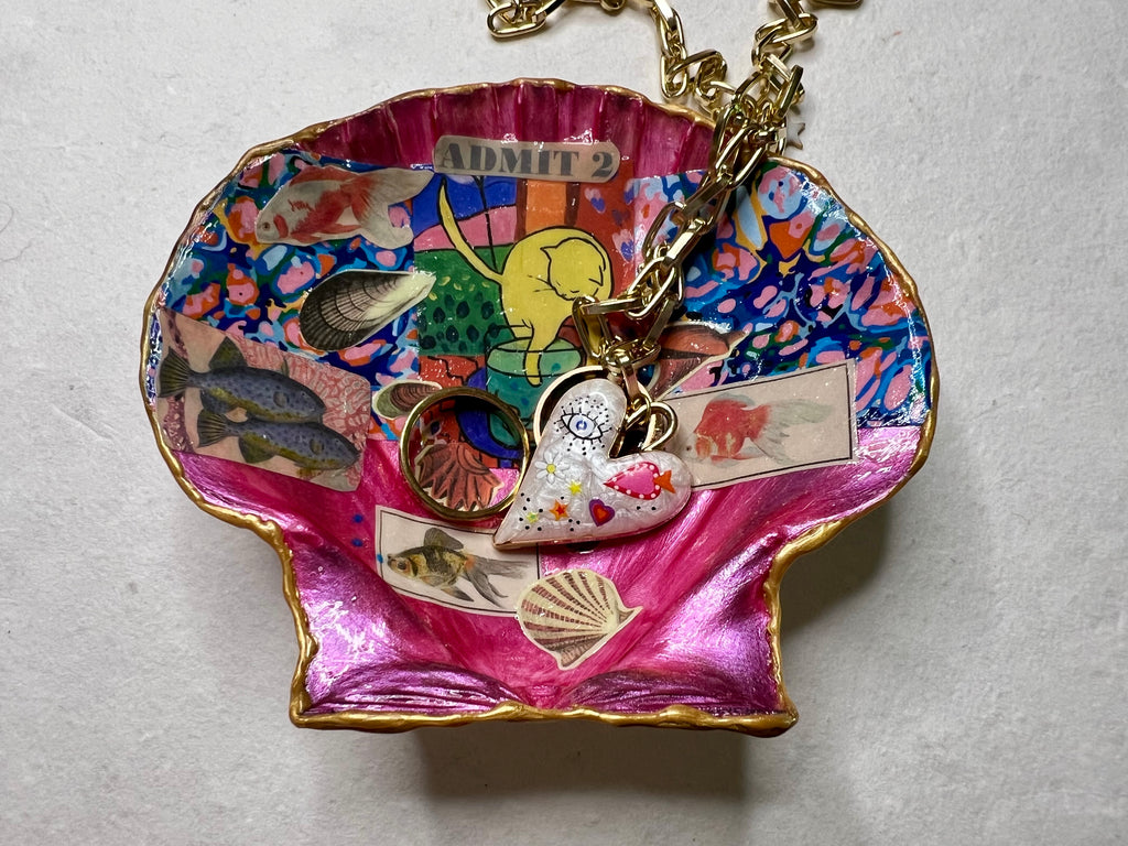 Vintage-inspired collage featuring fish and cat artwork on shell