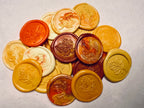 Collection of round, leaf-patterned seals in various colors on natural handmade paper
