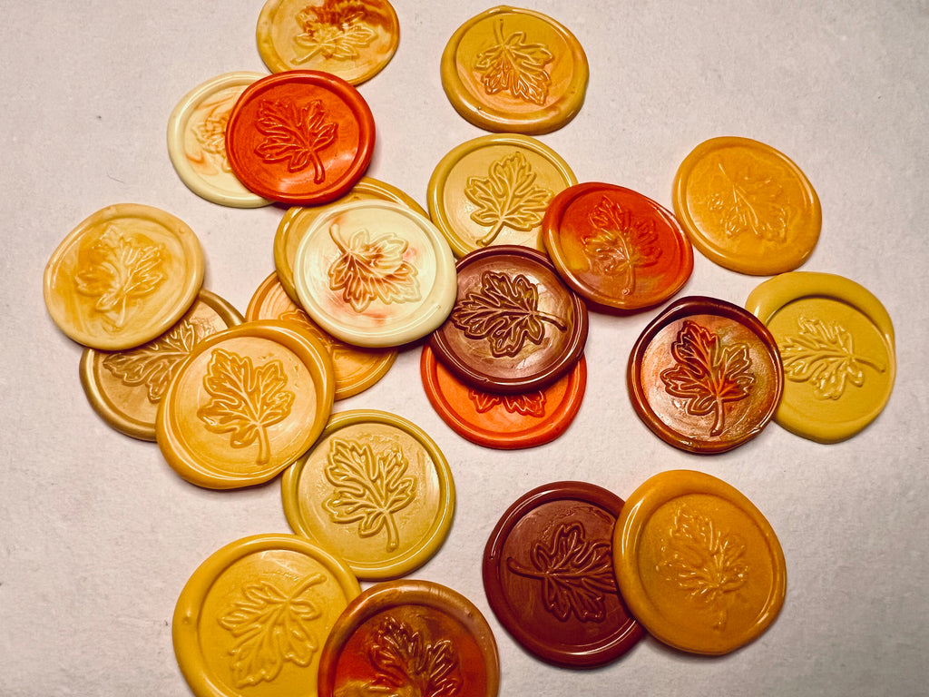Collection of Falling for You Maple Leaf Wax Seal Stickers - maple leaf-patterned seals in various colors on a neutral background