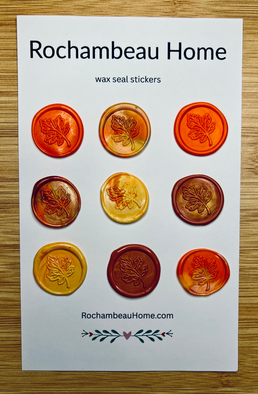 9 pack card of orange Falling for You Maple Leaf Wax Seal Stickers on a Rochambeau Home display card