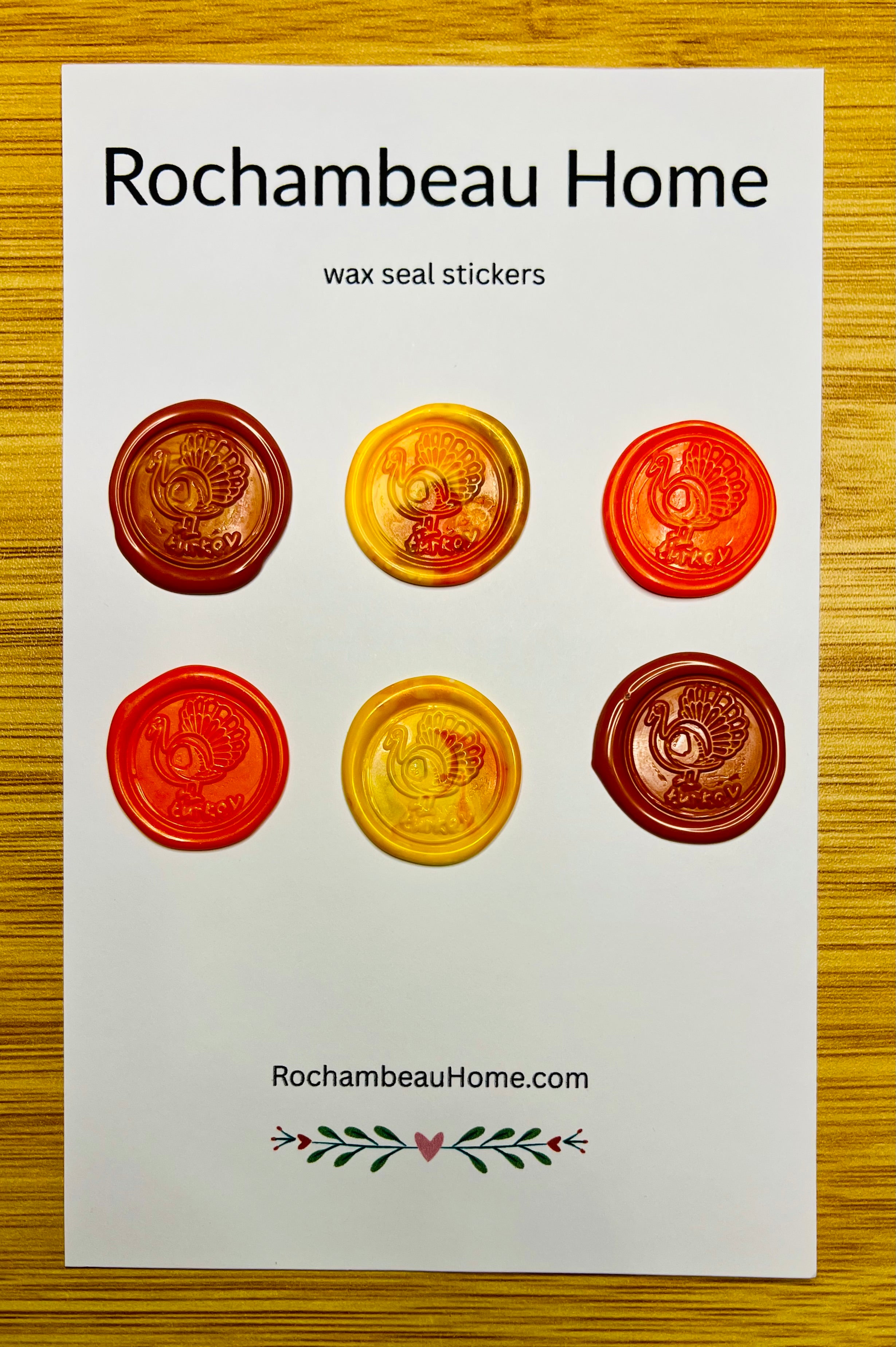 Packaging of Rochambeau Home Gobble & Glow wax seal stickers on a wooden surface