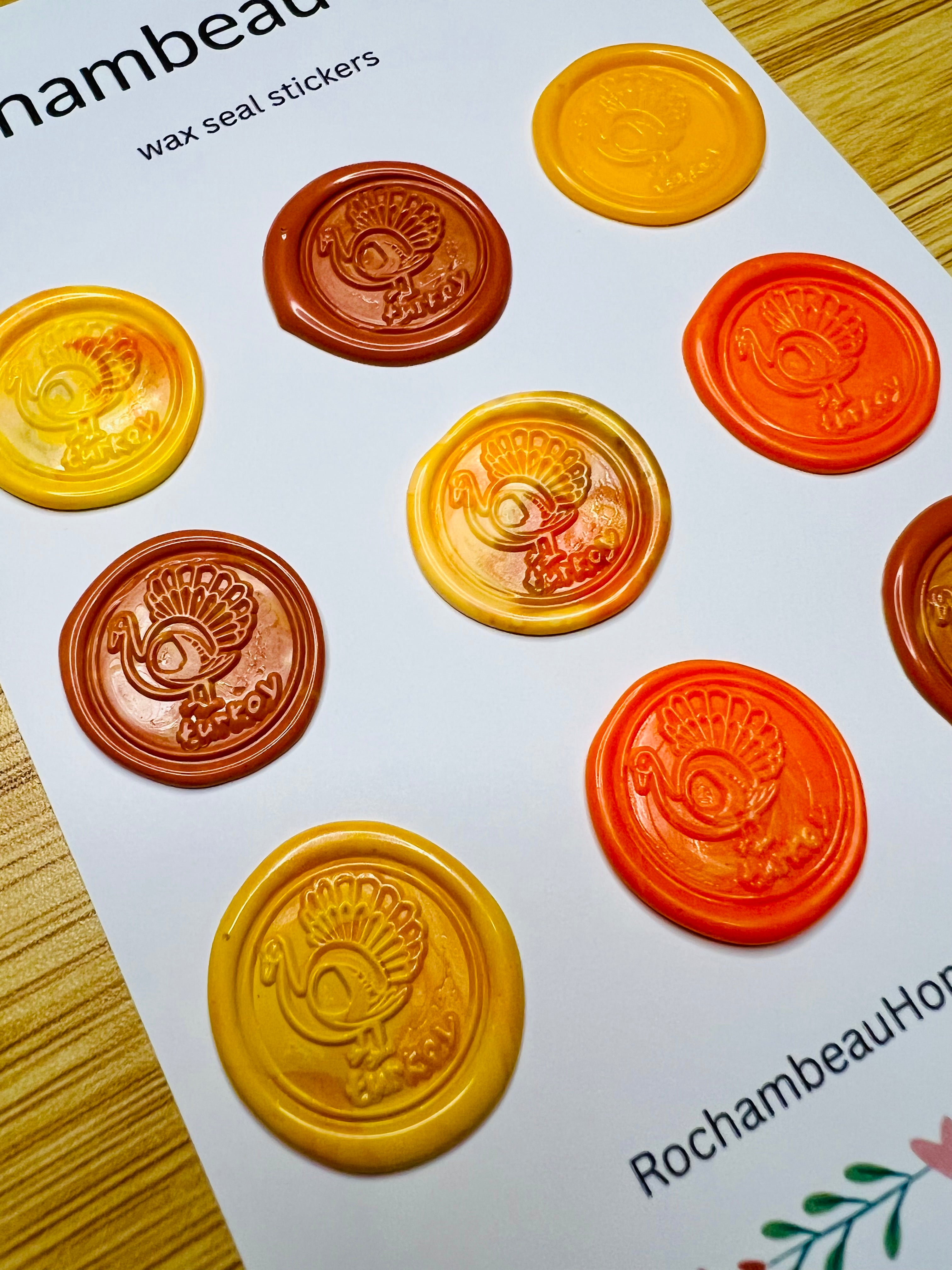 Wax seal stickers with turkey design on a white card, featuring colors yellow, orange, and brown.