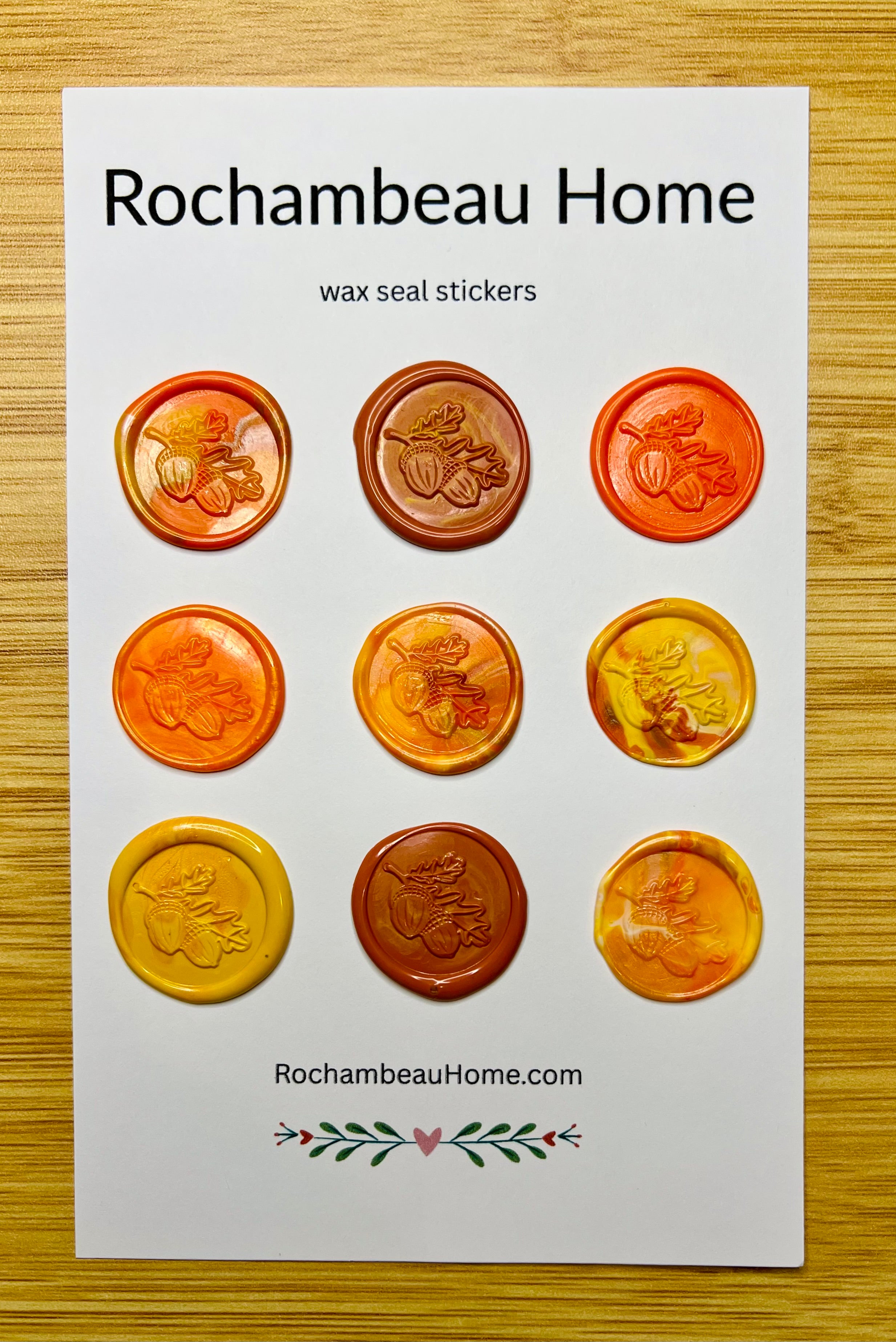 Set of wax seal stickers by Rochambeau Home on a white card with a wooden background.
