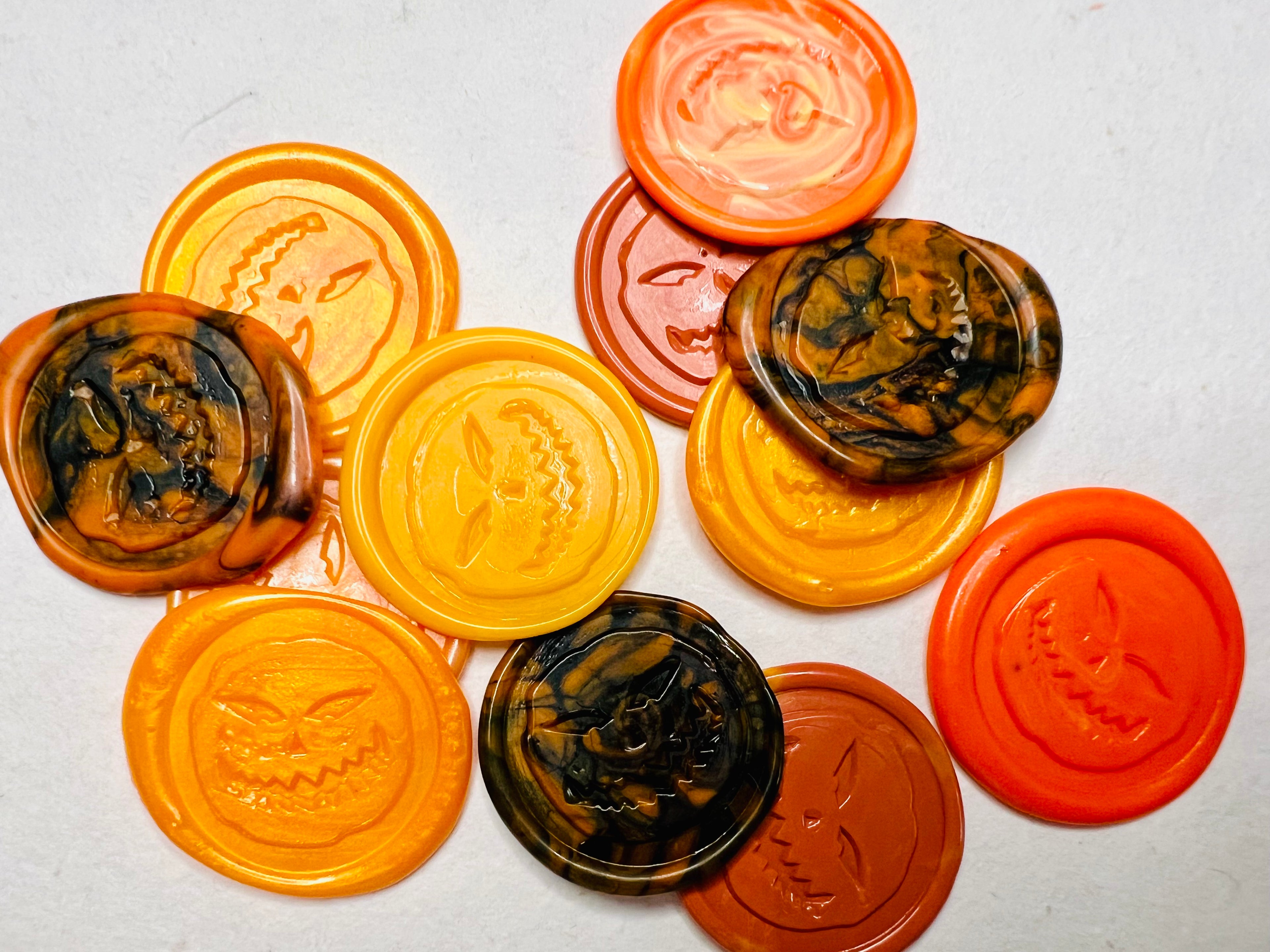 Angry Pumpkin wax seal stickers created with orange and black wax combinations 