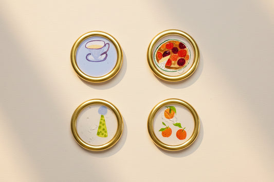 Set of four decorative wax seal magnets created by Rochambeau Home with whimsical illustrations and gold gilding wax.