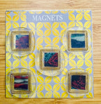 Set of square handcrafted wax seal magnets by Rochambeau Home with deep gold frames on a patterned display card labeled 'MAGNETS'.