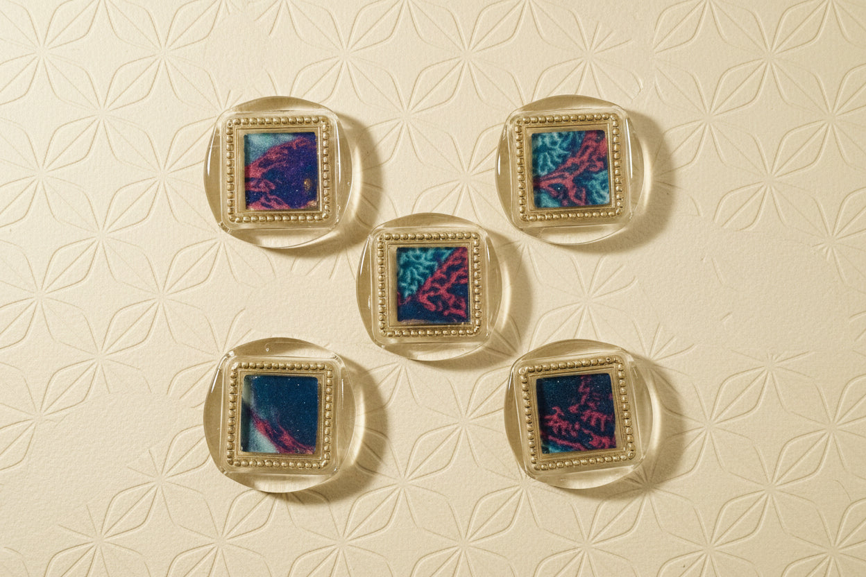 Set of five square wax seal magnets created by Rochambeau Home on a decorative background with floral pattern (deep gold)