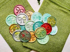 Festive Bow wax seal stickers created by Rochambeau Home in various colors  being showcased on green burlap bags.