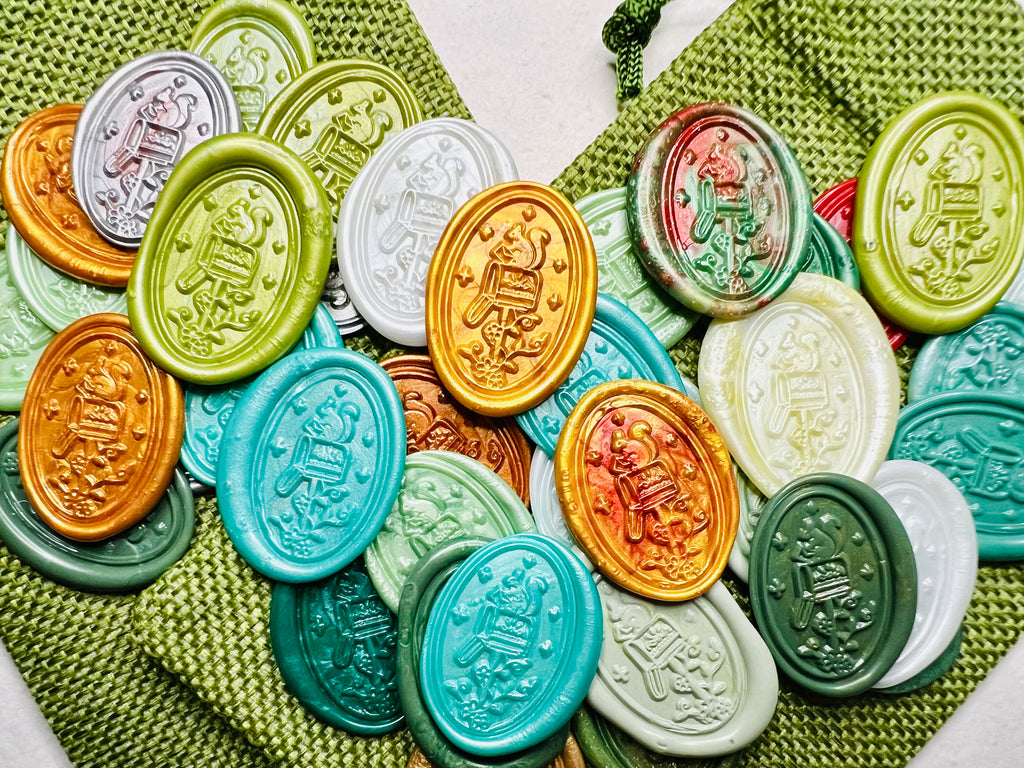 Squirrel Mail Christmas Wax Seal Stickers showcased on green burlap bags in a variety of festive and seasonal colors.