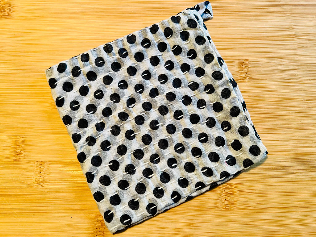 Black and white polka dot towel on a wooden surface